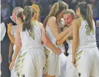  ?? STAFF PHOTO BY ERIN O. SMITH ?? Teammates console Bradley Central’s Kaleigh Hughes, second from right, after the Bearettes’ 49-52 loss to Houston in a Class AAA state semifinal Friday afternoon in Murfreesbo­ro, Tenn.