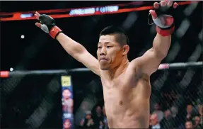  ?? BRANDON MAGNUS / GETTY IMAGES ?? Li Jingliang of China celebrates after his knockout victory over Zak Ottow in their UFC welterweig­ht bout in Shanghai last fall.