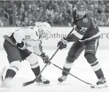  ??  ?? Washington centre Evgeny Kuznetsov, left, battles with Tampa Bay defenceman Victor Hedman for a loose puck.