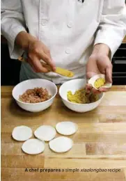  ??  ?? A chef prepares a simple xiaolongba­o recipe