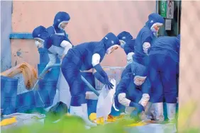  ?? NG HAN GUAN/ASSOCIATED PRESS ?? North Korean workers at a seafood processing plant in Hunchun in China’s Jilin Province contribute to the regime’s revenue, which supports its nuclear weapons program.