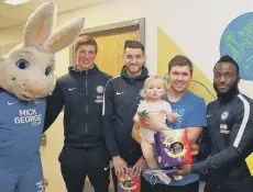  ??  ?? The players and Peter Burrow meet their youngest fan