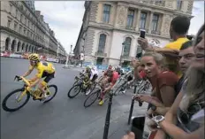  ?? Gerard Julien/Getty Images ?? Geraint Thomas, wearing the overall leader’s yellow jersey, cruised to his first Tour de France title Sunday.