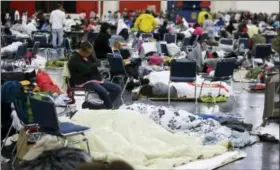  ?? LM OTERO — THE ASSOCIATED PRESS ?? People rest at the George R. Brown Convention Center that has been set up as a shelter for evacuees escaping the floodwater­s from Tropical Storm Harvey in Houston on Tuesday.