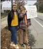  ?? SHAEL NORRIS VIA AP ?? In this Monday, Oct. 7 photo provided by Shael Norris, high school sophomore Aela Mansmann, 15, of Cape Elizabeth, Maine, left, stands with her brother Aidan, 13, as he displays a placard during a school walkout, in Cape Elizabeth.