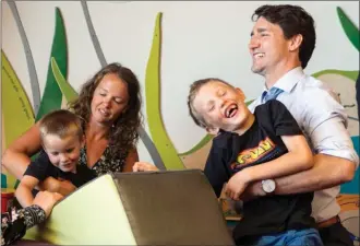  ?? The Canadian Press ?? Prime Minister Justin Trudeau meets Heather Musselman and her sons River, Elden and Harvey during a photo opportunit­y Friday in Markham, Ont. Trudeau said NAFTA remains the preferred option for ensuring prosperity for workers across North America.