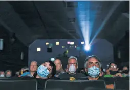  ??  ?? Dozens watch the start of CatVideoFe­st at the Roxie Theater after a long pandemic closure and a period of viewing cat videos at home.