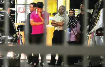  ?? MOHD RASFAN/AFP ?? A North Korean Embassy official (centre) leaves the forensics department, where the body of Kim Jong-nam is being kept, at the Hospital Kuala Lumpur in Kuala Lumpur on Wednesday.