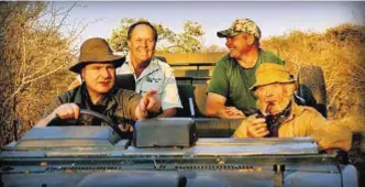  ??  ?? Film director driving with Guy Wallace and safari hunters