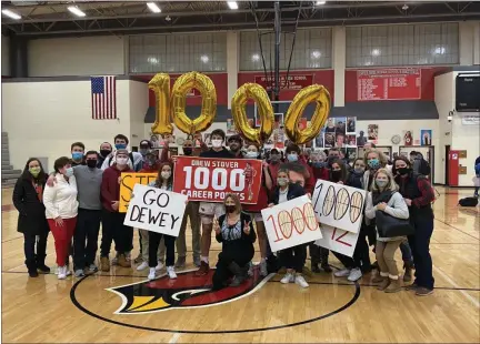  ?? MIKE CABREY/MEDIANEWS GROUP ?? Upper Dublin’s Drew Stover takes a picture with family and friends to celebrate scoring his 1,000th career point in the Cardinals’ win over Hatboro-Horsham on Thursday, Feb. 11, 2021.