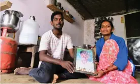  ??  ?? Latha Bollapally, with her son Rajesh Goud, holds a picture of her husband, Madhu Bollapally, 43, a migrant worker who died in Qatar. Photograph: Kailash Nirmal