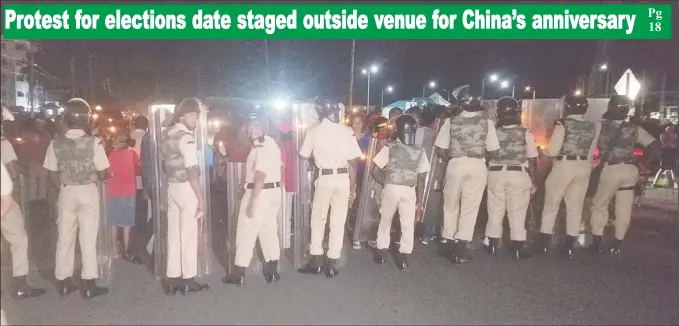  ?? (Shamar Meusa photo) ?? Police ranks with their riot shields as they prevented the protesters from getting closer to the Arthur Chung Conference Centre