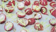  ?? MELISSA D’ARABIAN THE ASSOCIATED PRESS ?? The recipe tops plain roasted radishes with a quick green goddess dressing made from Greek yogurt, lemon juice, dill and parsley.