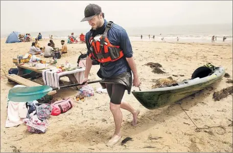  ?? Al Seib Los Angeles Times ?? TAMLORN CHASE, a wilderness guide, filmmaker and environmen­tal activist, returns to a crowded Gaviota State Beach after paddling his kayak over to Hollister Ranch, a “holdout case” that remains limited to landowners and select visitors. That may soon change.