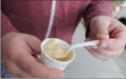  ?? LAUREN HALLIGAN — DIGITAL FIRST MEDIA ?? An event-goer enjoys New England Clam Chowder from Muddaddy Flats on Third Street in downtown Troy.