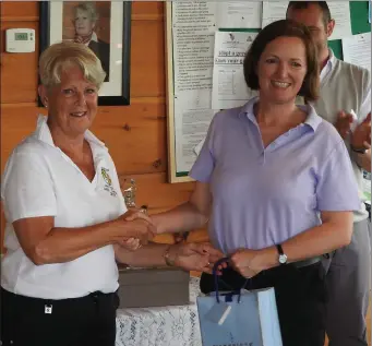  ??  ?? Lady Captain’s Day winner Ann-Marie Ennis receiving first prize from Lady Captain Elaine Collins at Bellewstow­n Golf Club.