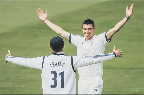  ?? PICTURE: ALEX WHITEHEAD/SWPIX.COM ?? IN FULL SWING: Yorkshire’s Matthew Fisher celebrates with Will Fraine after taking the wicket of Durham’s Alex Lees.