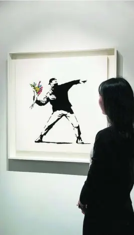  ??  ?? La obra de Banksy subastada y adjudicada en criptomone­das