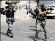  ?? AP/MAHMOUD ILLEAN ?? Israeli police take aim with tear-gas launchers Friday during a confrontat­ion with Palestinia­ns in Jerusalem’s Old City.