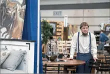  ?? Alexandra Wimley/Post-Gazette photos ?? John Yoder staffs a booth for Twin Locust Furniture of Fredericks­burg, Ohio, at Pittsburgh Home & Garden Show.