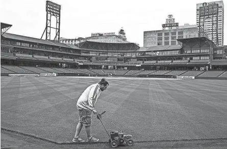  ?? BRAD VEST/THE COMMERCIAL APPEAL ?? March 25, 2016: Ben Young, head groundskee­per at Autozone Park, edges the outfield grass along the warning track. “We’re restricted by the weather so we can’t start until it’s nice outside,” Young said about his busy schedule preparing the field before the season.