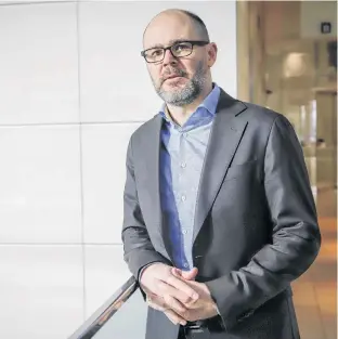  ?? THE CANADIAN PRESS/JEFF MCINTOSH ?? James Mccreath, a portfolio manager with BMO Nesbitt Burns Private Client Division, outside a BMO branch in Calgary, Alta. on Feb. 13. For Canadians who’ve made faithful contributi­ons to an RRSP for most of their working lives, converting it to an RRIF may seem a terrifying milestone.