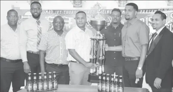  ??  ?? Banks Beer Manager, Brian Nedd (centre) presenting the Championsh­ip Trophy to Nazrudeen Mohamed (second from right) in the presence of NSC Director Chris Jones (2nd left) and Banks DIH managers and organisers of the event yesterday