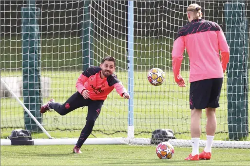  ?? — AFP ?? Manchester City midfielder Bernardo Silva punches a ball away during a training session on the eve of their Champions League quarterfin­al first leg against Real Madrid.