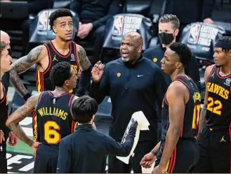  ?? Curtis Compton / Associated Press ?? Nate Mcmillan took over after the Hawks’ 14-20 start. The team responded by going 27-11, and reached the conference final after ousting East No. 1 seed Philadelph­ia.