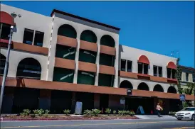  ?? ?? A woman walks toward a public parking garage in downtown Riverside on Thursday.