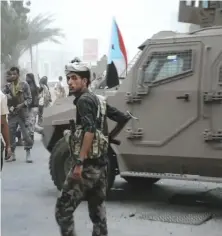  ?? AP ?? A fighter stands in front of an armored vehicle in the center of Aden .