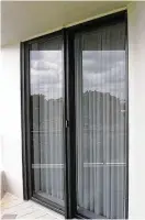  ?? Photo courtesy of Dreamscree­ns ?? The retractabl­e screen covers just the moveable side of a sliding glass door. The matching screen door frame is barely noticeable.