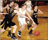  ?? PHOTO COURTESY OF SHELLEY WILLIAMS ?? Prairie Grove’s Ashley Cox and Taylor Doss battle a Pottsville player for control of the ball during the 4A North Regional girls basketball tournament at Pottsville. A strong nonconfere­nce schedule toughened up the Lady Tigers, who have had to battle...