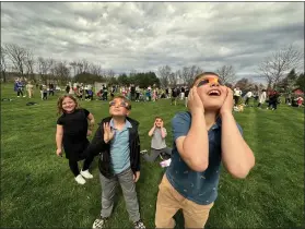  ?? PHOTO BY JEN SAMUEL FOR THE DAILY LOCAL NEWS ?? Students watch the eclipse on Monday at Upland Country Day School in East Marlboroug­h.