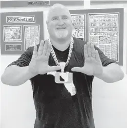  ?? DAVID FURONES/SUN SENTINEL edition of Miami’s chain ?? AJ Machado, the Turnover Chain jeweler, shows off his fourth that highlights all of South Florida.