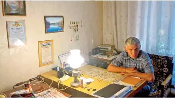  ??  ?? Svystelnyk, director of the care home “House of Veteranshe­ad” sit in his cabinet in the village of Novomykhay­livka, in the Ukraine’s war-torn region, on June 20. Authoritie­s have relocated several of the worst-hit care homes but most are forced to...