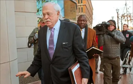  ?? Robert Cohen/ St. Louis Post- Dispatch ?? Pathologis­t Dr. Michael Baden, front, arrives to testify before the grand jury on the Michael Brown shooting in 2014 in Clayton, Mo. Baden, who also testified for O. J. Simpson’s defense in the “trial of the century” and helped investigat­e the assassinat­ions of President John F. Kennedy and Dr. Martin Luther King Jr. is now enmeshed in another high- stakes case. Baden is the private pathologis­t who observed Jeffrey Epstein’s autopsy on his lawyers’ behalf.