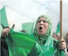  ?? — GETTY IMAGES ?? A woman takes part in a rally marking the 30th anniversar­y of the founding of Hamas, in Gaza City Thursday.