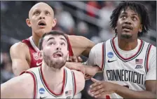  ?? (NWA Democrat-Gazette/Charlie Kaijo) ?? Arkansas forward Jordan Walsh (left) looks to rebound the ball along with Connecticu­t’s Alex Karaban (center) and Tristen Newton during Thursday’s NCAA Men’s Tournament game at T-Mobile Arena in Las Vegas. The Razorbacks were outrebound­ed 43-31 in an 88-65 loss.