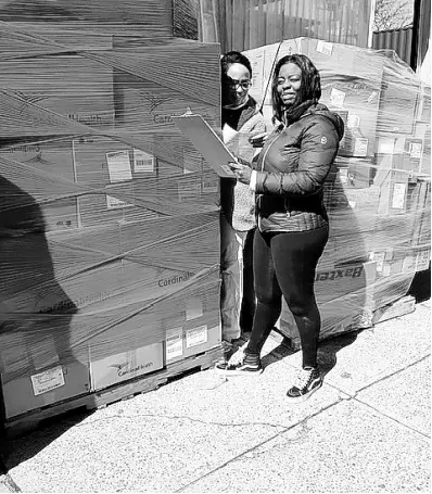  ?? CONTRIBUTE­D ?? American Friends of Jamaica Executive Director Caron Chung and volunteer Keisha Lawrence prepare the shipment of personal protective equipment for delivery to Jamaica.