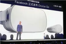  ?? — Reuters ?? A screen shows Facebook founder Mark Zuckerberg as Xiaomi founder Lei Jun introduces a new VR headset during a product launch in Shenzhen.