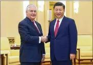  ?? LINTAO ZHANG / ASSOCIATED PRESS ?? U.S. Secretary of State Rex Tillerson (left) shakes hands with China’s President Xi Jinping at the Great Hall of the People in Beijing on Sunday.