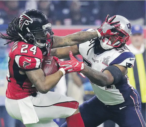  ?? — THE ASSOCIATED PRESS ?? Atlanta Falcons’ Devonta Freeman runs against New England Patriots’ Dont’a Hightower during the second half.