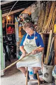  ??  ?? g Jacquelyn Johnson is almost dwarfed by her walking stick cabbage plants i Sanding and staining the stems with varnish to make the finished product