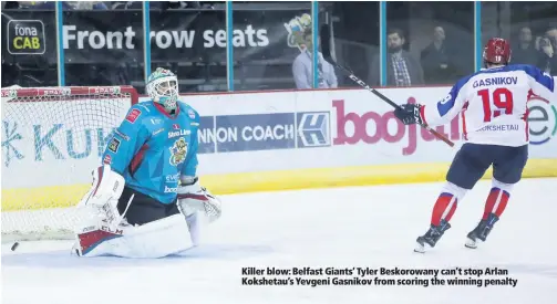  ??  ?? Killer blow: Belfast Giants’ Tyler Beskorowan­y can’t stop Arlan Kokshetau’s Yevgeni Gasnikov from scoring the winning penalty