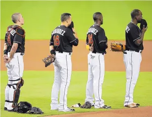  ?? LYNNE SLADKY/ASSOCIATED PRESS ?? Marlins, from left, catcher J.T. Realmuto, Martin Prado, Adeiny Hechavarri­a and Marcell Ozuna stand during a pregame ceremony honoring Jose Fernandez.