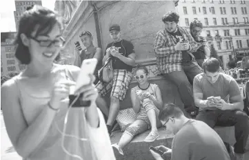  ??  ?? Gamers play the Nintendo Co. Pokemon Go game on Fifth Avenue in New York, US last Wednesday, July 13. — WP-Bloomberg photo