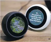  ?? ASSOCIATED PRESS FILE ?? Amazon Echo Spots are displayed during a program announcing several new Amazon products by the company. The round version of the Echo Spot has its own 2.5-inch display that can provide visual informatio­n, such as the weather or a clock face.