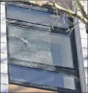  ??  ?? TOO CLOSE: A bullet was fired through this window Tuesday at Victory Collegiate HS in Canarsie, Brooklyn, just missing a girl’s head before striking a digital chalkboard.