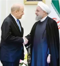  ??  ?? Iranian President Hassan Rouhani shakes hands with French Foreign Minister Jean-Yves Le Drian in Tehran. France has criticized Iran’s missile program and raised the possibilit­y of new sanctions. (AFP)